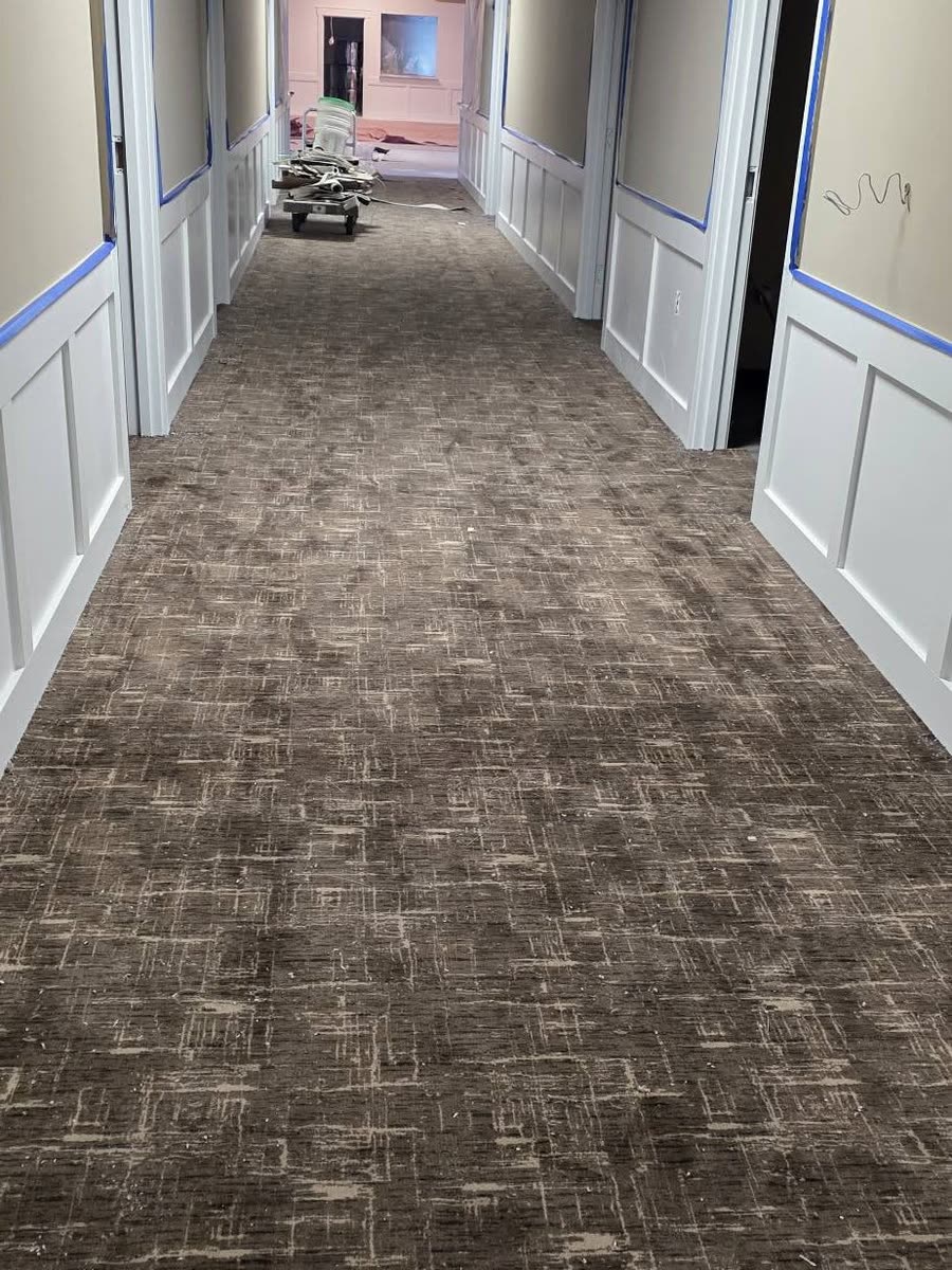 Textured carpet in a wainscoted corridor
