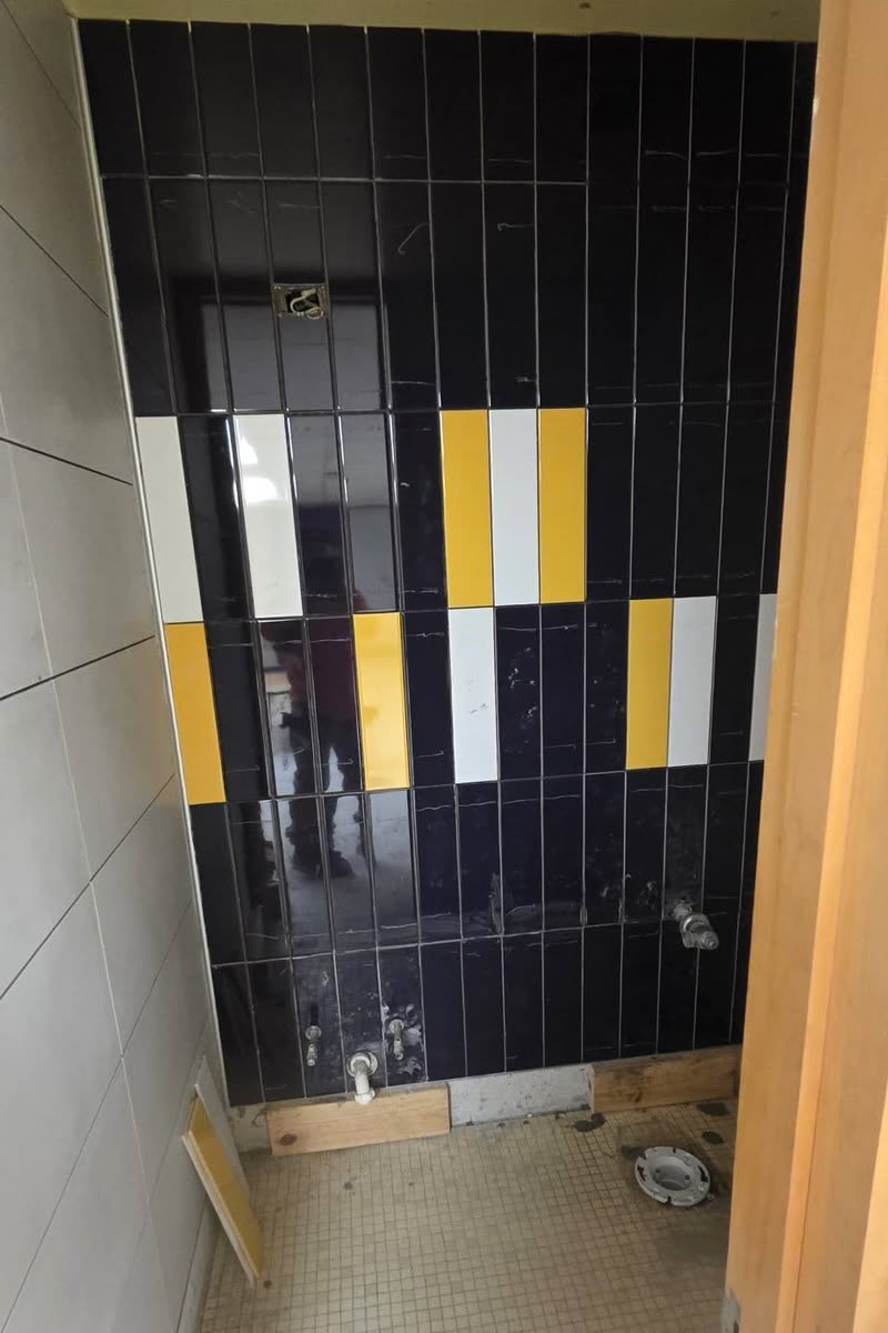 Black, yellow, and white feature tile wall