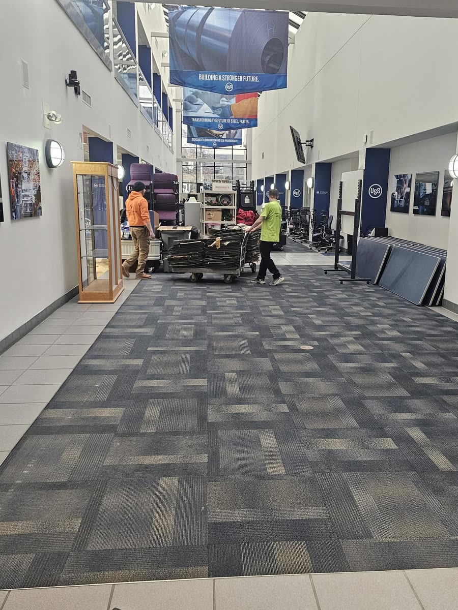 Crew installing carpet tile in an atrium